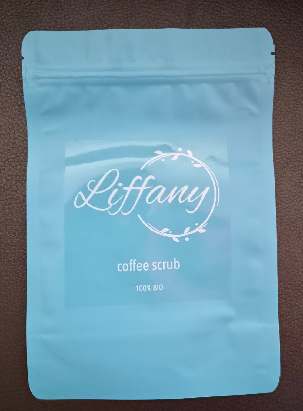 Liffany coffee scrub in a turquoise pouch
